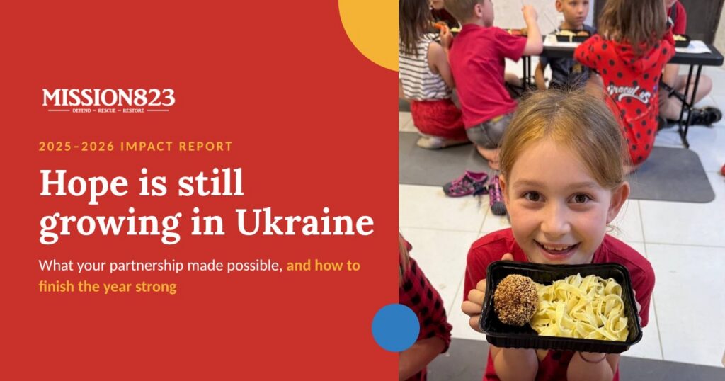Smiling girl holding a warm meal at the Mission 823 feeding program for children in Ukraine, with the words Hope is still growing in Ukraine, 2025–2026 Impact Report