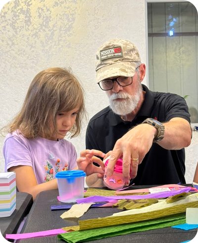 Shawn Sullivan doing crafts with a girl at the Nikopol feeding center